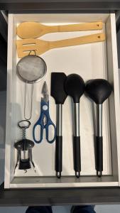 a drawer filled with different types of kitchen utensils at Studios Gago 167 in Suzano +11 photos