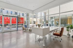 an office with a desk and chairs and windows at Placemakr Downtown Phoenix in Phoenix