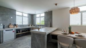 a kitchen with a table and chairs in it at Casa Brisa Bonita Villa with Private Pool in Cas Grandi in Jan Thiel