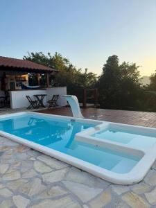 a large pool with a slide on a patio at recanto da pedra in Paraty