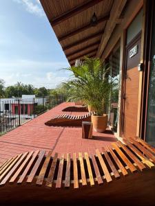 a wooden bench sitting outside of a building at Casa Ampa Zikatela- Brisas de Zicatela- Puerto Escondido in Brisas de Zicatela +92 photos