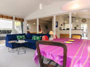 a living room with a blue couch and a table at 6 person holiday home in Stege in Tyrholm +38 photos