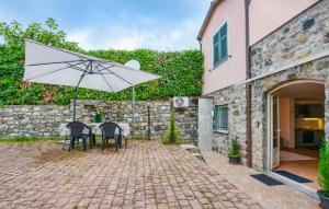 a patio with a table and an umbrella at 1 Bedroom Stunning Apartment In Masso in Castiglione Chiavarese