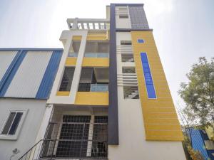 a building with yellow and blue paint on it at Hotel O Home RBS Homes in Hyderabad