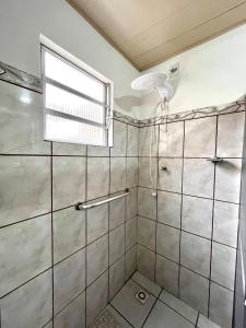 a bathroom with a shower and a window at Casa Buarque de Macêdo 494 in Rio Grande +17 photos