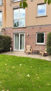 a house with two chairs and a bench in front of it at Stylish Guest home in Dublin +13 photos