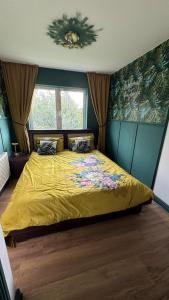 a bedroom with a bed with a yellow bedspread at Stylish Guest home in Dublin