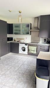 a kitchen with a washing machine in the middle at Stylish Guest home in Dublin