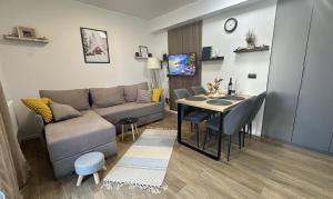 a living room with a couch and a dining room table at NORD VISTA Premium Alpine and SPA Experience in Kopaonik