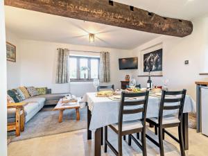 a living room with a table and a couch at 2 Bed in Taunton 93581 in Norton Fitzwarren