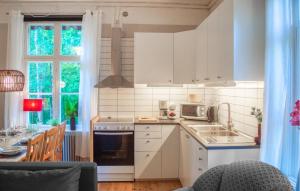 a kitchen with a sink and a stove top oven at Cozy Apartment In Storfors With Wifi in Storfors