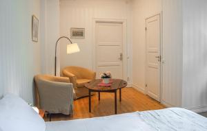 a bedroom with a bed and a table and a chair at Cozy Apartment In Storfors With Wifi in Storfors