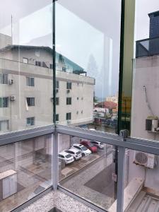 a view of a parking lot from a window at Residencial Spader - Bombinhas in Bombinhas