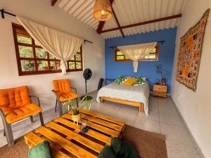 a bedroom with a bed and a wooden table at El Nido Andino in La Mesa