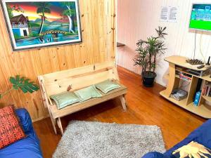 a living room with a bench with pillows on it at Casarão das Figueiras in Caxias do Sul