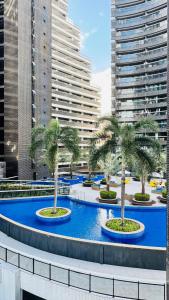 a large pool with palm trees in front of buildings at landscap Meireles Fortaleza in Fortaleza