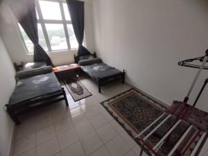 a living room with black furniture and a window at Homestay Saderi Putrajaya Presint 16 in Putrajaya +3 photos