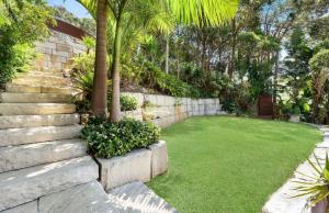 a garden with a lawn with stairs and palm trees at Paraiso Del Mar - by Coast Hosting in Copacabana +24 photos