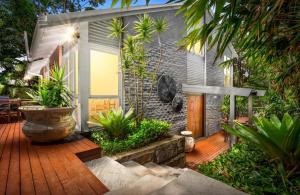 a house with a wooden deck with plants at Paraiso Del Mar - by Coast Hosting in Copacabana