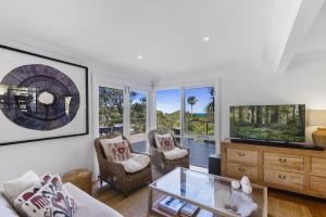 a living room with a couch and a tv at Paraiso Del Mar - by Coast Hosting in Copacabana