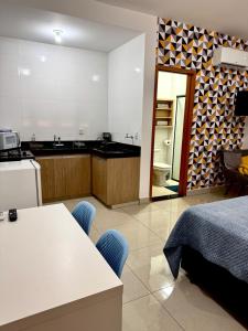 a kitchen with a bed and a table with chairs at Blue Life Torre 1 in Anápolis +9 photos