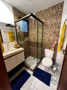 a bathroom with a shower and a toilet and a sink at Bangalô aconchegante e luxuoso Winterville Resort Gravatá PE in Gravatá