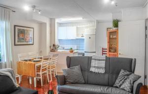 a living room and kitchen with a couch and a table at Nice Apartment In Storfors With Wifi in Storfors