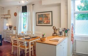a kitchen with a table and chairs in a room at Nice Apartment In Storfors With Wifi in Storfors
