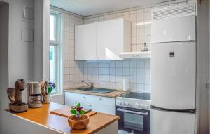a kitchen with white appliances and a wooden counter top at Nice Apartment In Storfors With Wifi in Storfors