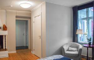 a bedroom with a bed and a chair and a window at Nice Apartment In Storfors With Wifi in Storfors +5 photos