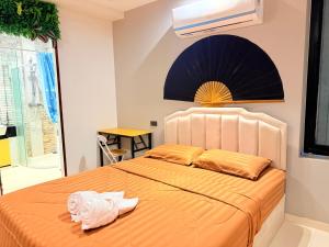 a bedroom with an orange bed with towels on it at Pool Villa Viewthalay in Ko Chang +61 photos