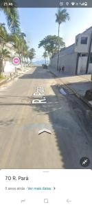 a screenshot of a street with a sign on the side at Beach Milionario in Guarujá +7 photos