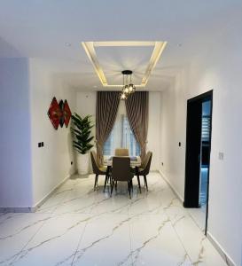 een eetkamer met een tafel en stoelen bij D-Lezzubra Luxury Apartments in Gwarinpa