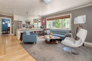 a living room and kitchen with a couch and a table at Classic Palo Alto Home & Neighborhood in Palo Alto