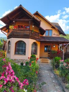 a house with flowers in front of it at Casa Georgeta in Câmpulung Moldovenesc