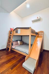a bunk bed in a room with wooden floors at Azure Residences, PJ Paradigm By Kiddie Space, Kids Friendly in Petaling Jaya +23 photos