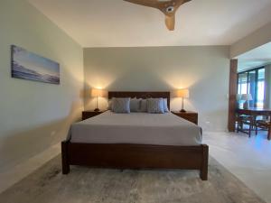 a bedroom with a bed with two lamps and a table at Mauna Lani Point Newly Furnished ocean golf views in Waikoloa +39 photos