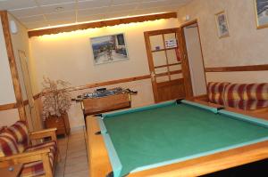 a living room with a pool table in it at La Boule de Neige in Samoëns