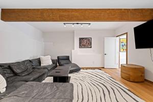 a living room with a couch and a tv at Spectacular Bolinas Oceanfront Retreat in Bolinas