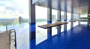 a building with a pool with a view of the city at Azure Residences, PJ Paradigm By Kiddie Space, Kids Friendly in Petaling Jaya