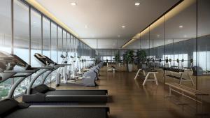 a gym with rows of treadmills in a building at Azure Residences, PJ Paradigm By Kiddie Space, Kids Friendly in Petaling Jaya