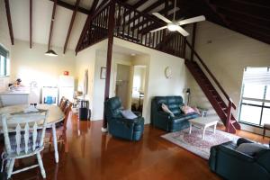 a living room and dining room with a table and chairs at Kurrajong Trails and Cottages in Colo