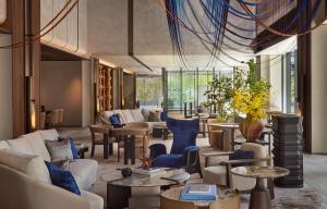 a lobby with couches and chairs and tables at Dusit Thani Kyoto in Kyoto