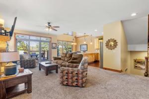 a living room with a couch and a table at Sleep 12-big Sandy Lodge V10-lakefront-luxury in McGregor
