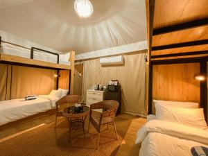 a bedroom with two bunk beds and a table and chairs at LasCalas Resort and Luxury Estate in Dasol