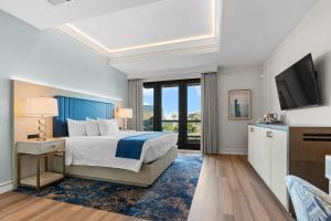 a hotel room with a bed and a television at Harbor Suites at Harborwalk Village in Destin