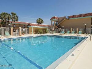 a large swimming pool in front of a hotel at 2 BR Condo in St Augustine across from Beach in Saint Augustine