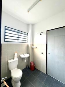 a bathroom with a toilet and a sink at Salak Lestari Homestay Klia Klia2 in Sepang