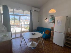 a living room with a table and a refrigerator at Appartement F3 à la Marina Pointe-du-Bout, Martinique - FR-1-765-33 in Lazaret