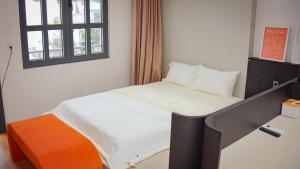 a small bed in a room with a window at Be Staycation Sai Gon in Ho Chi Minh City